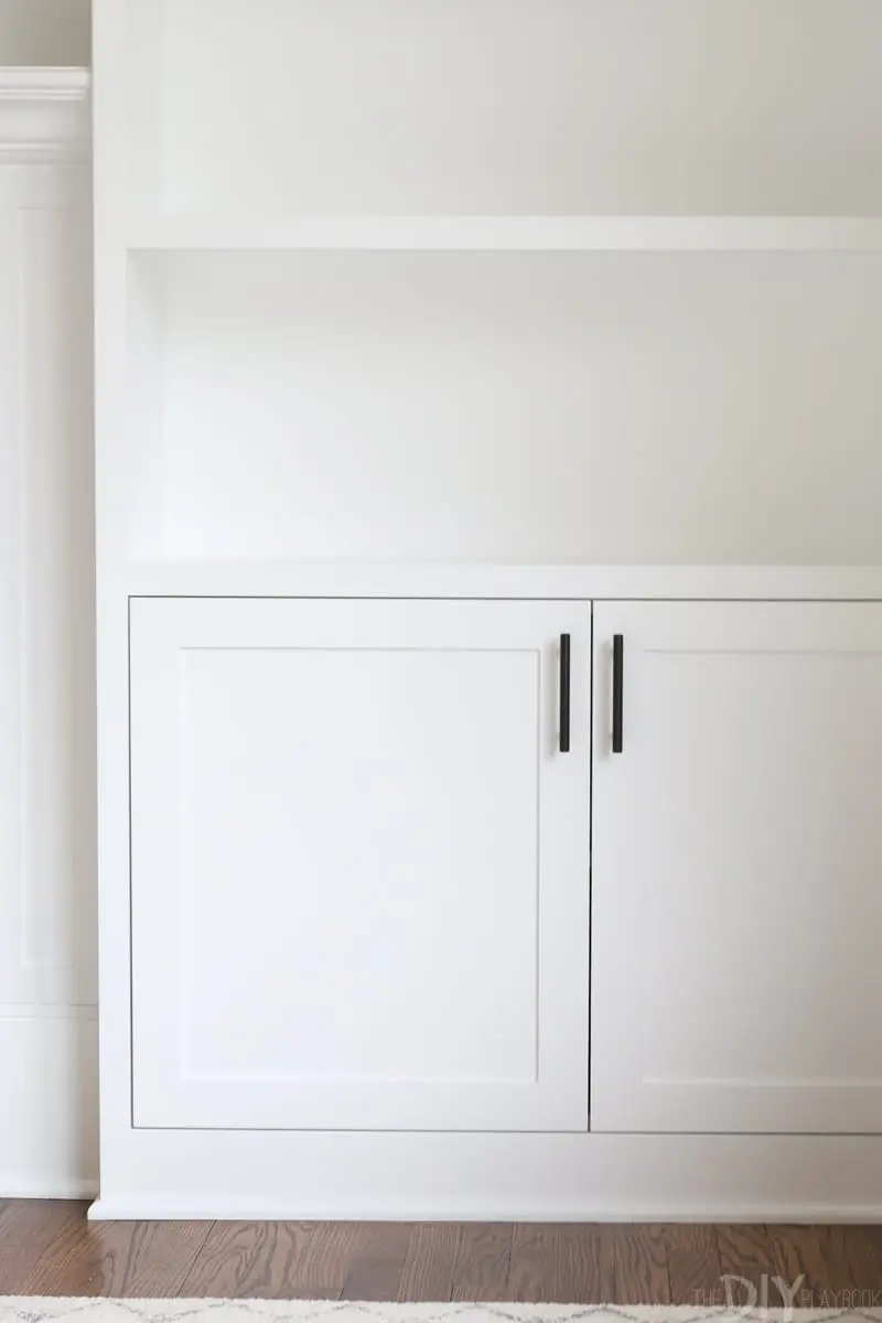 white built-ins with black hardware