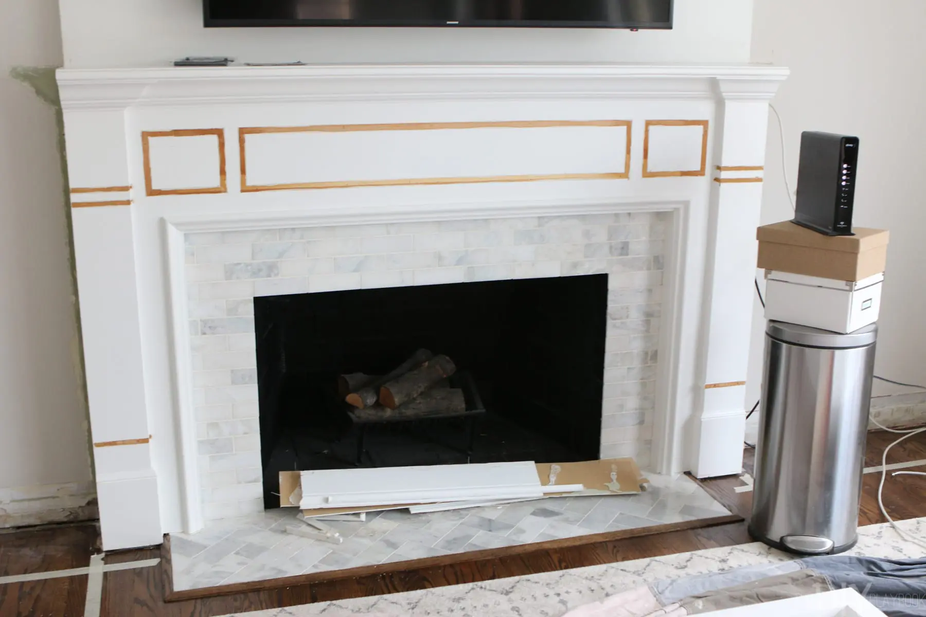 changing the wood detail before installing Whte Built-Ins Around a Fireplace