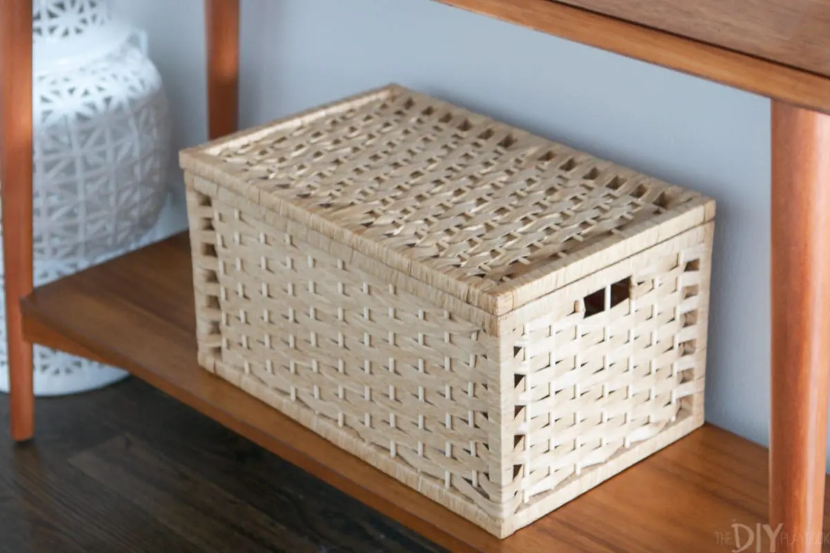 Use a lidded basket to hide clutter in your hallway