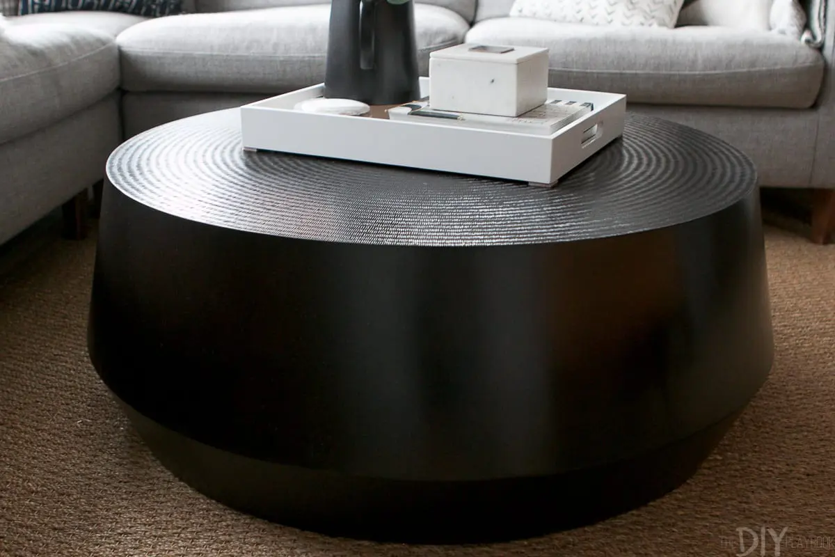 The black round coffee table from Crate and Barrel is the perfect choice for this living room makeover. 