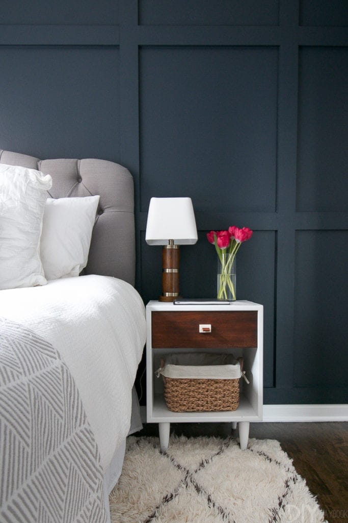 two-toned nightstand on a navy wall