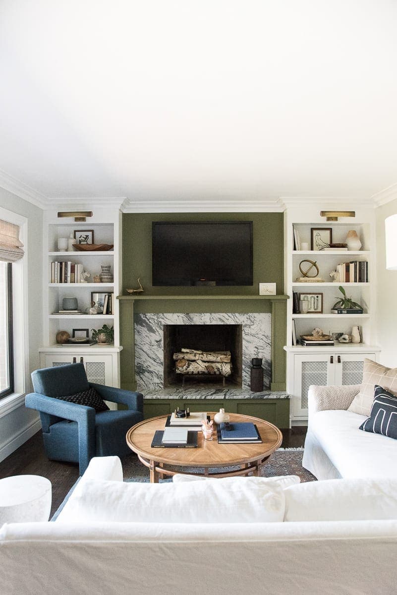 DIY built-ins in a living room with a green fireplace surround. 