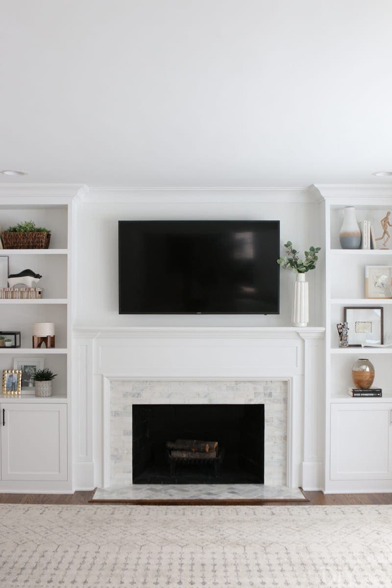 Looking to update your old fireplace? This step-by-step process takes you through how we transformed our old fireplace into a white marble tile fireplace that we absolutely love.