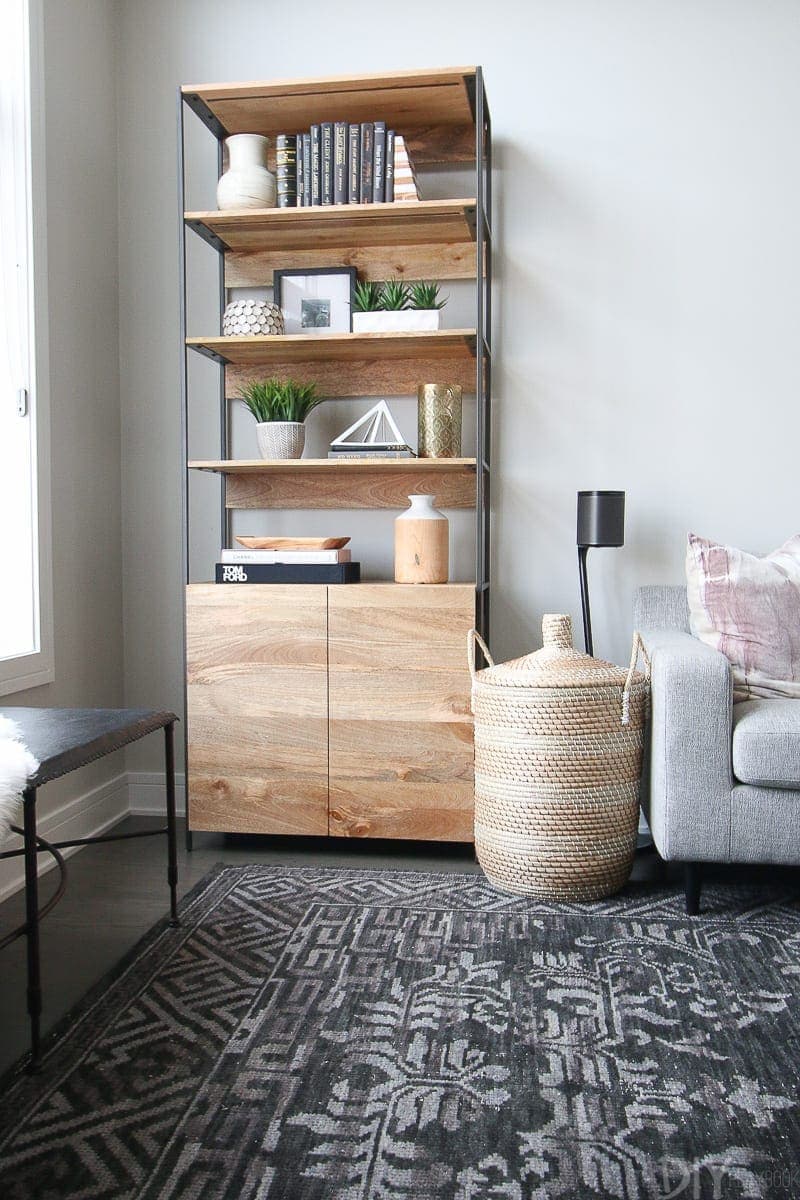 Wood bookcase from West Elm to hold pretty accessories in a family room.