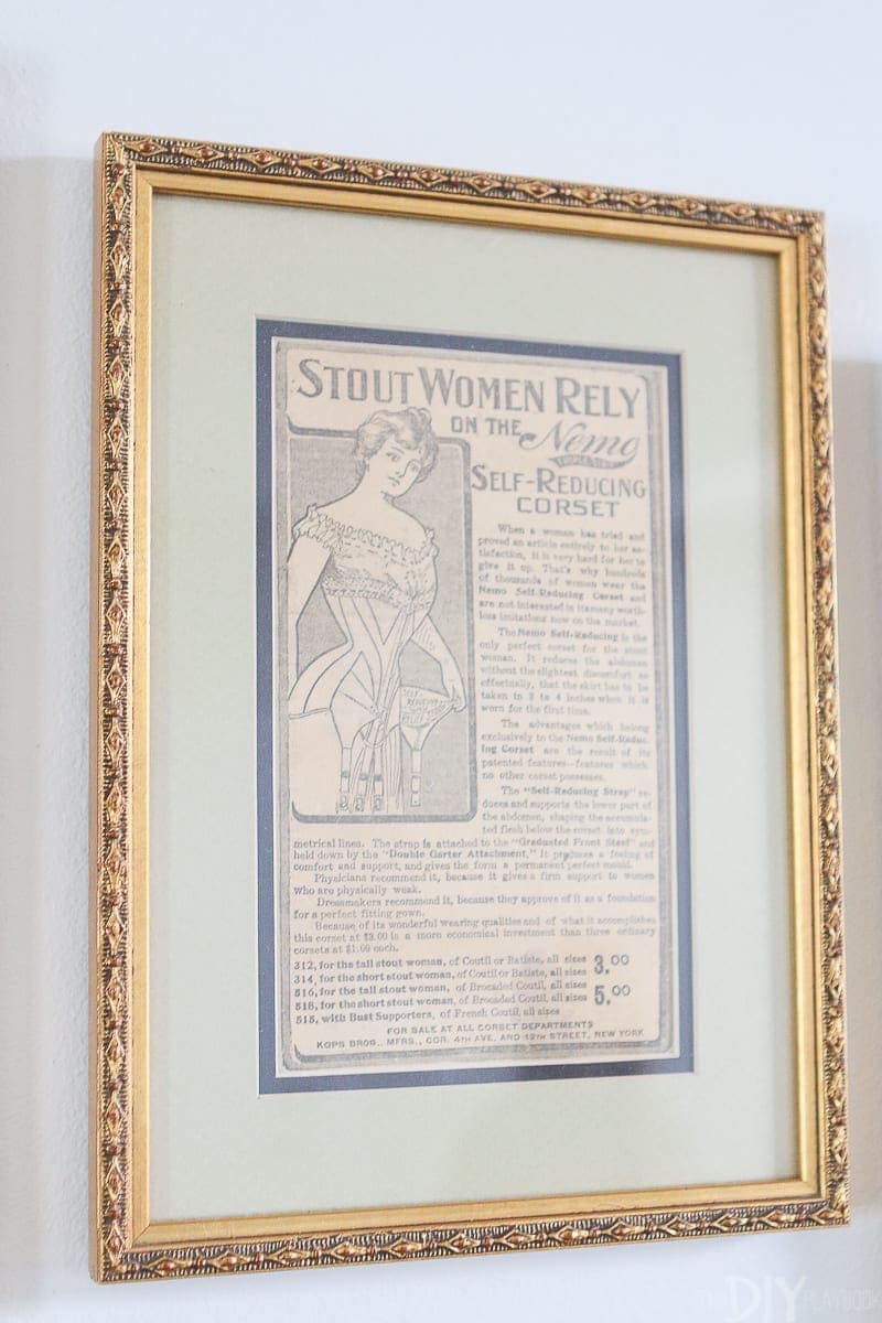 An old newspaper clipping in an antique gold frame