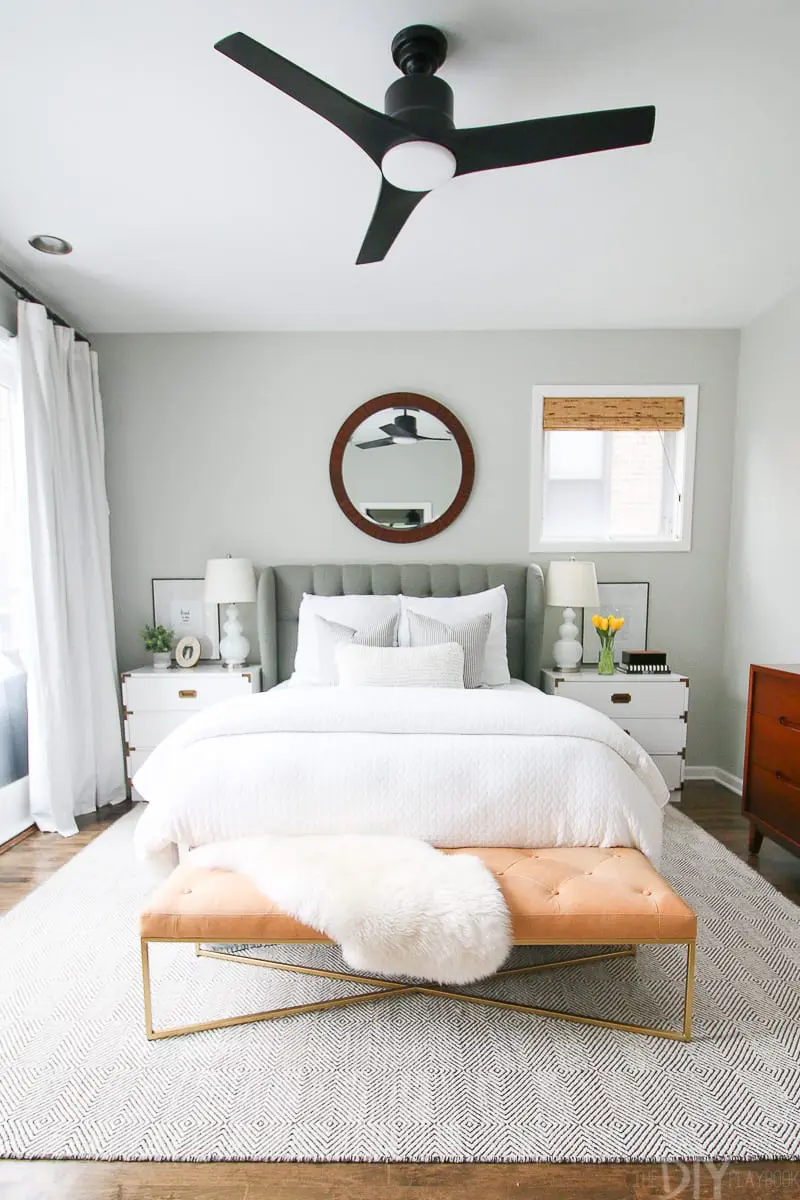 Gray walls, white bedding, and neutral accents are always a good bedroom combination.