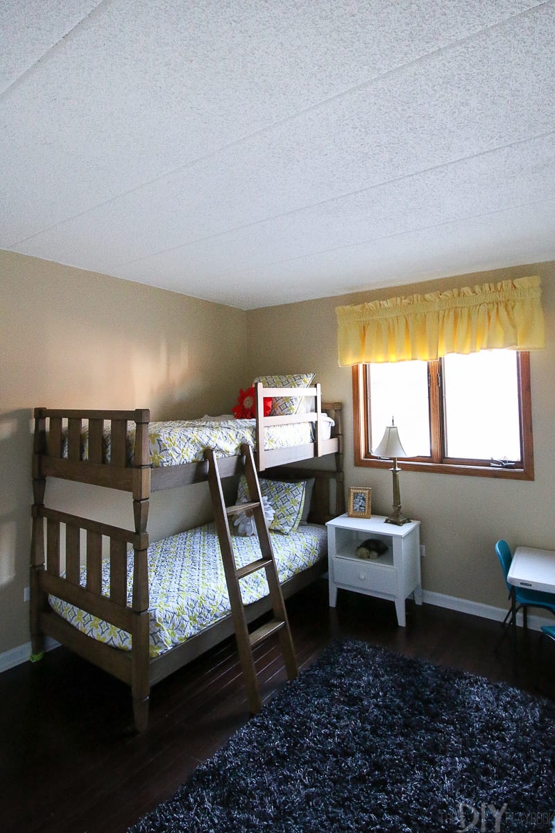 A kids' room before the makeover with popcorn ceilings. 