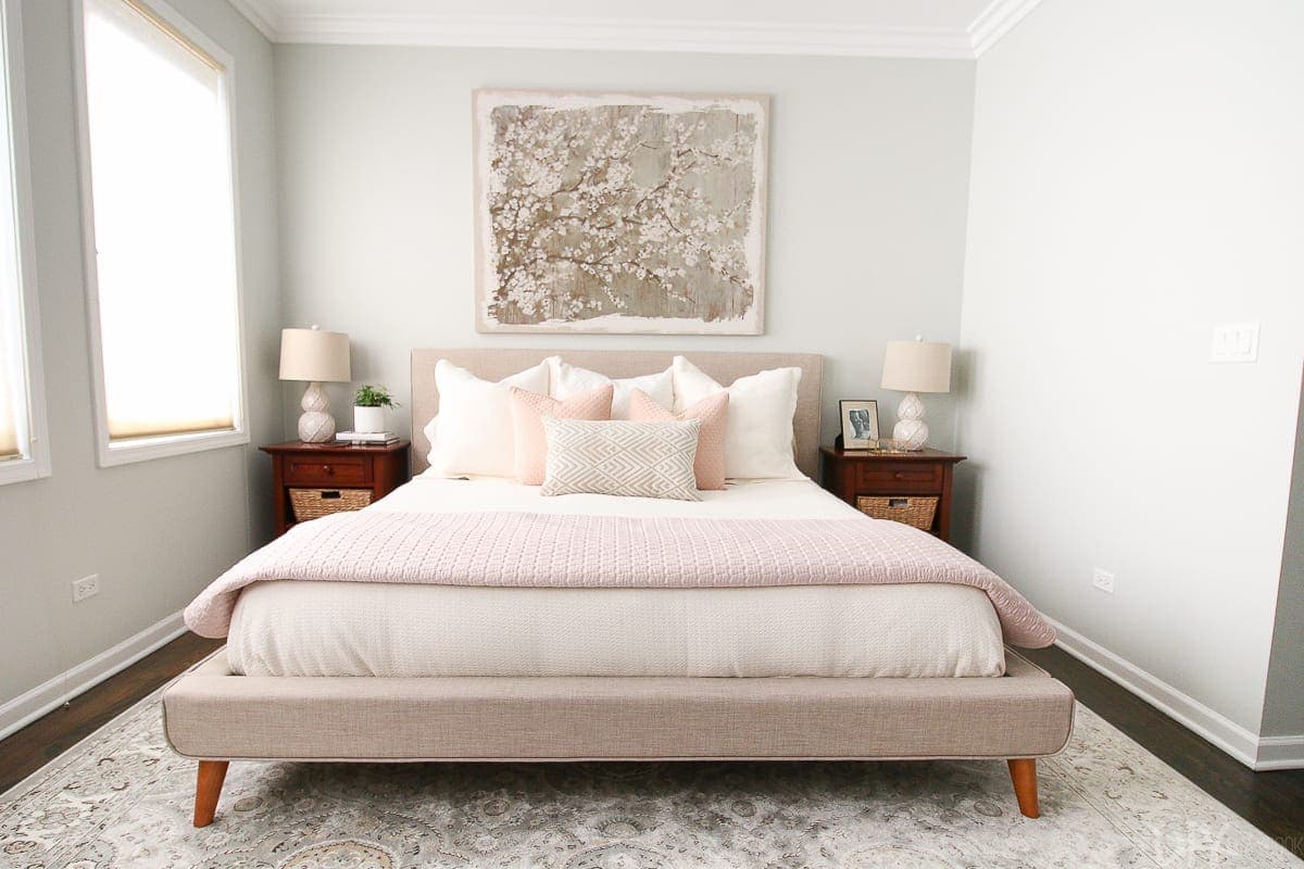 A neutral bedroom with blush accents to create a feminine space. 