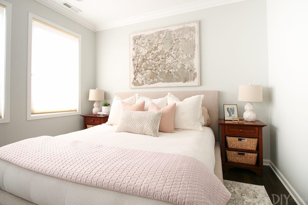 A blush bedroom with gray walls and beige accents.