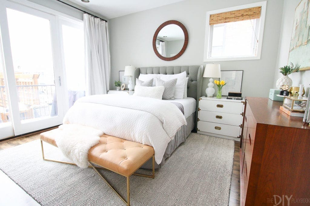 Gray master bedroom with neutral accessories