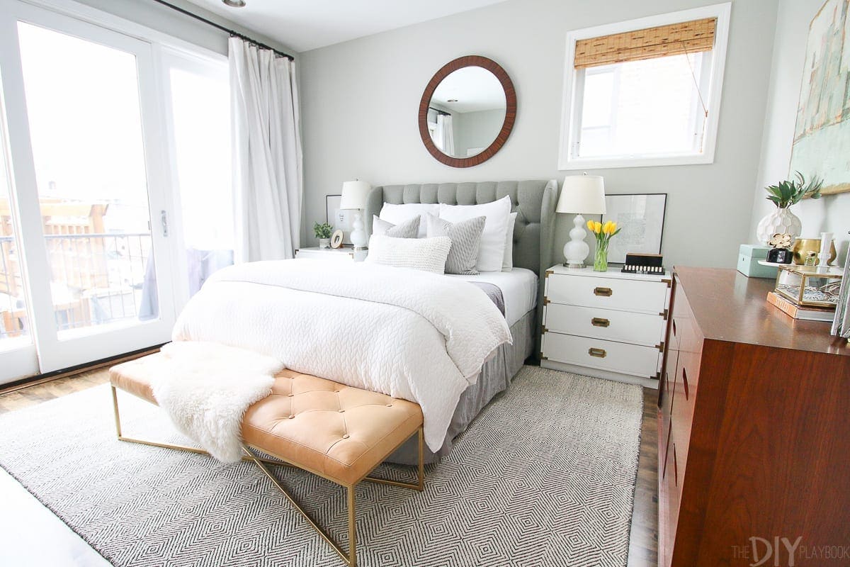 A gray bedroom with white bedding in the beautiful bedroom tour. 