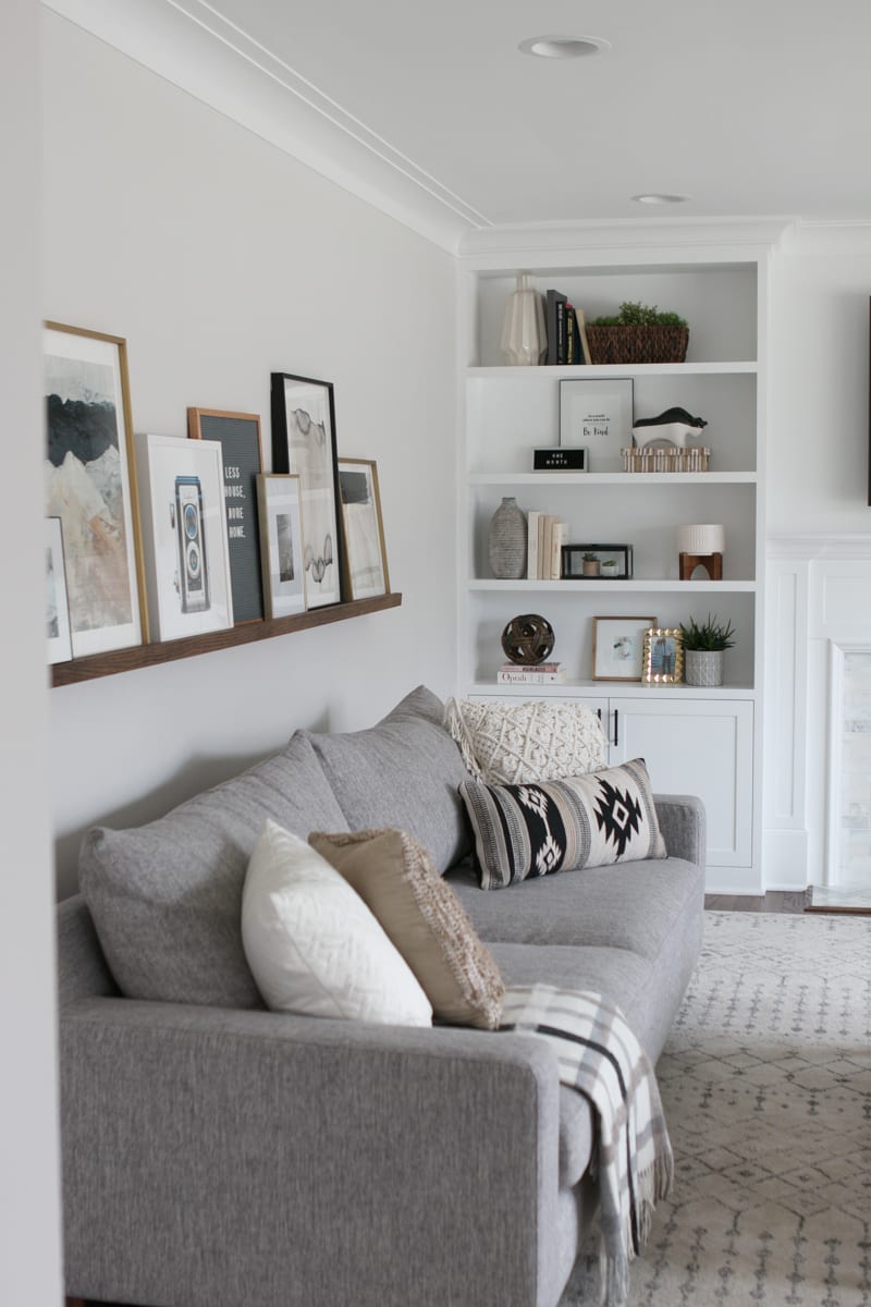 This DIY picture ledge works perfectly over the couch to display art in your family room. 