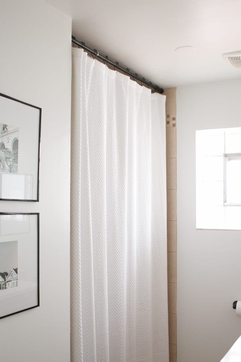 Use an XL white shower curtain to hide ugly shower tile. 