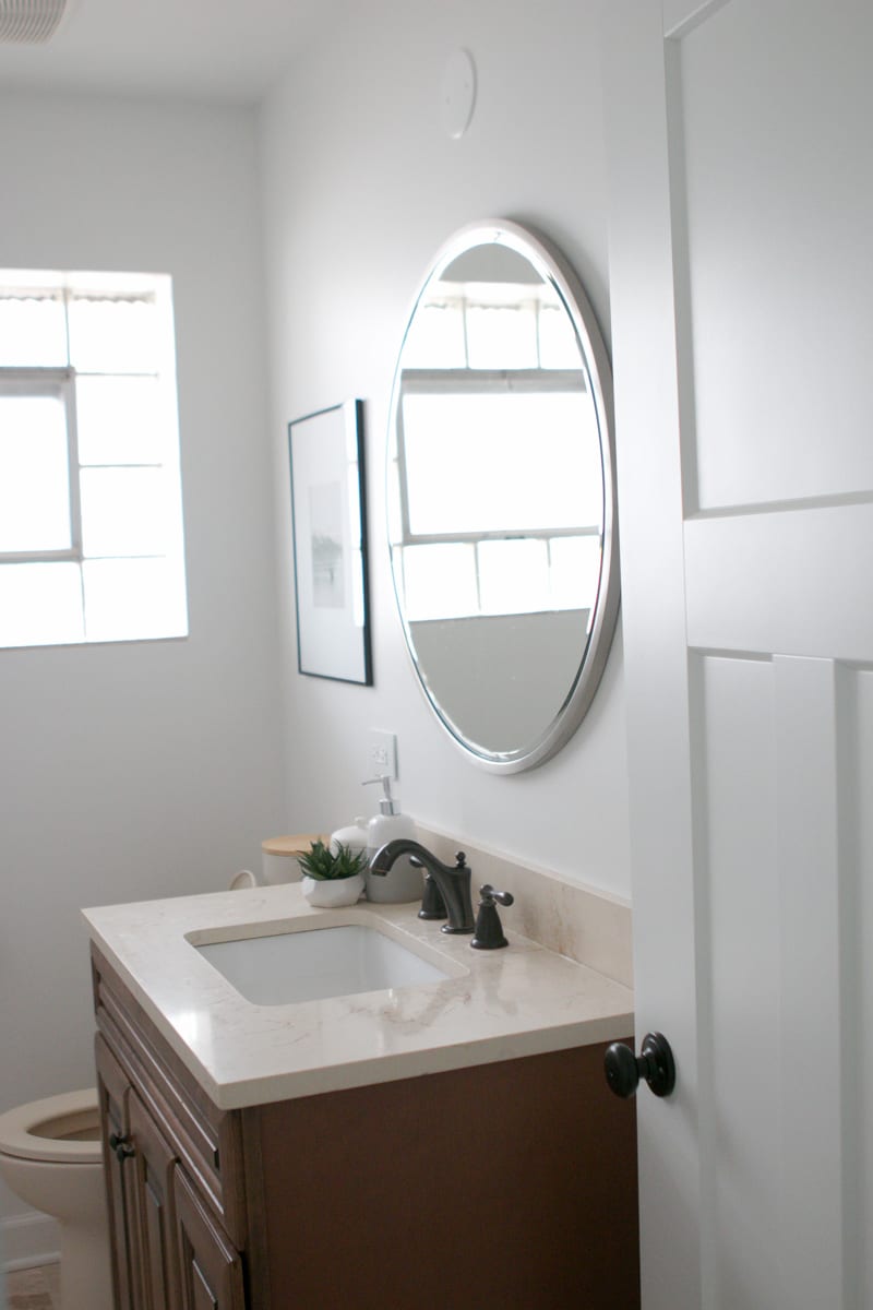Paint the walls and swap the mirror in the bathroom for a fresh look in this space. 