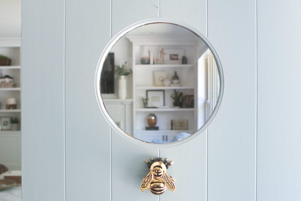 bee door knocker on a blue front door