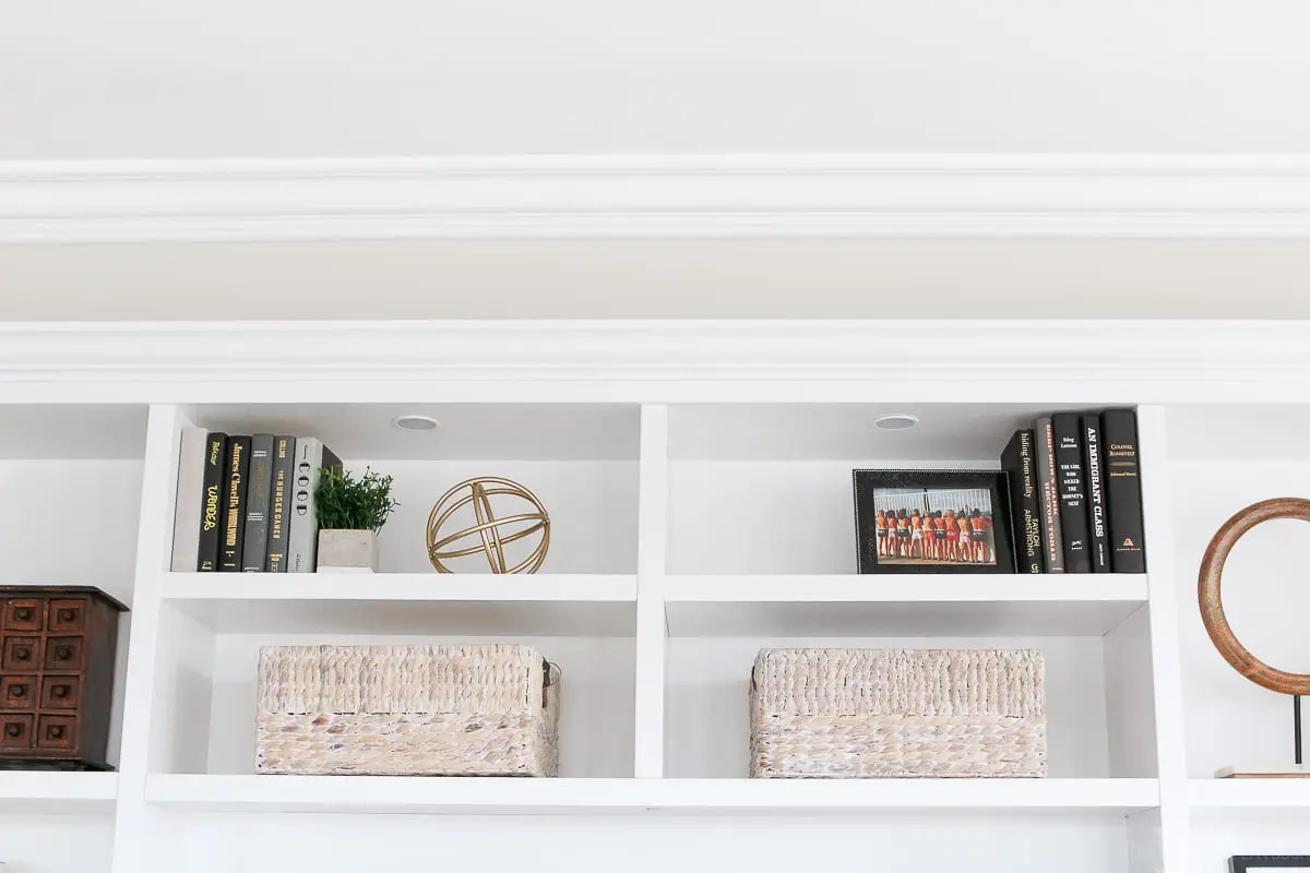 Add baskets to bookshelves for extra storage. 