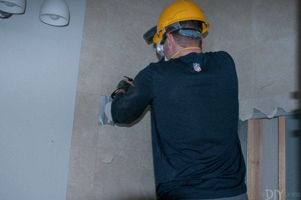 A hard hat is a must when removing tile from your shower walls. 