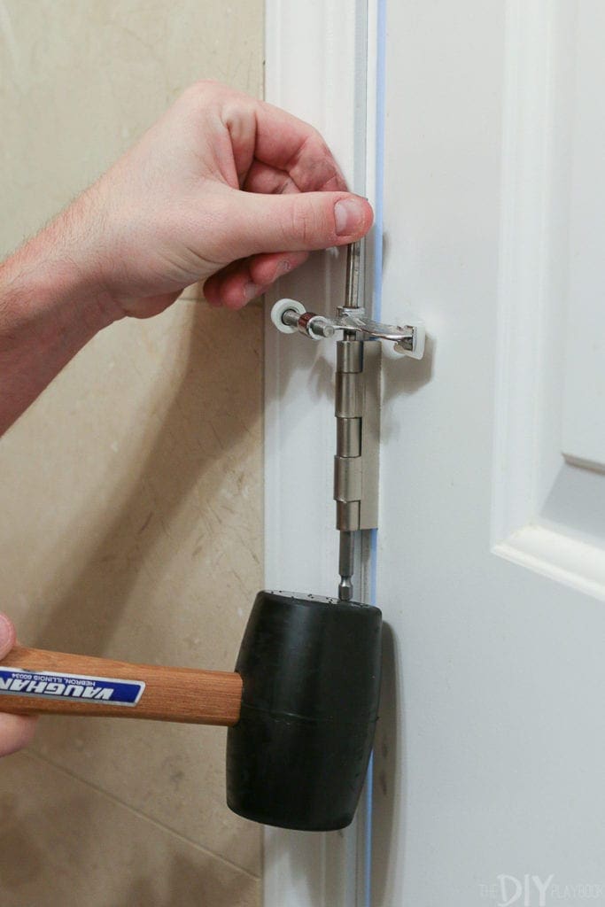 Use a mallet to remove a door off its hinges