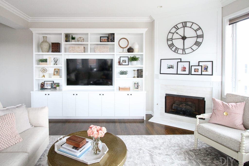 White built-in bookshelves with a shiplap fireplace