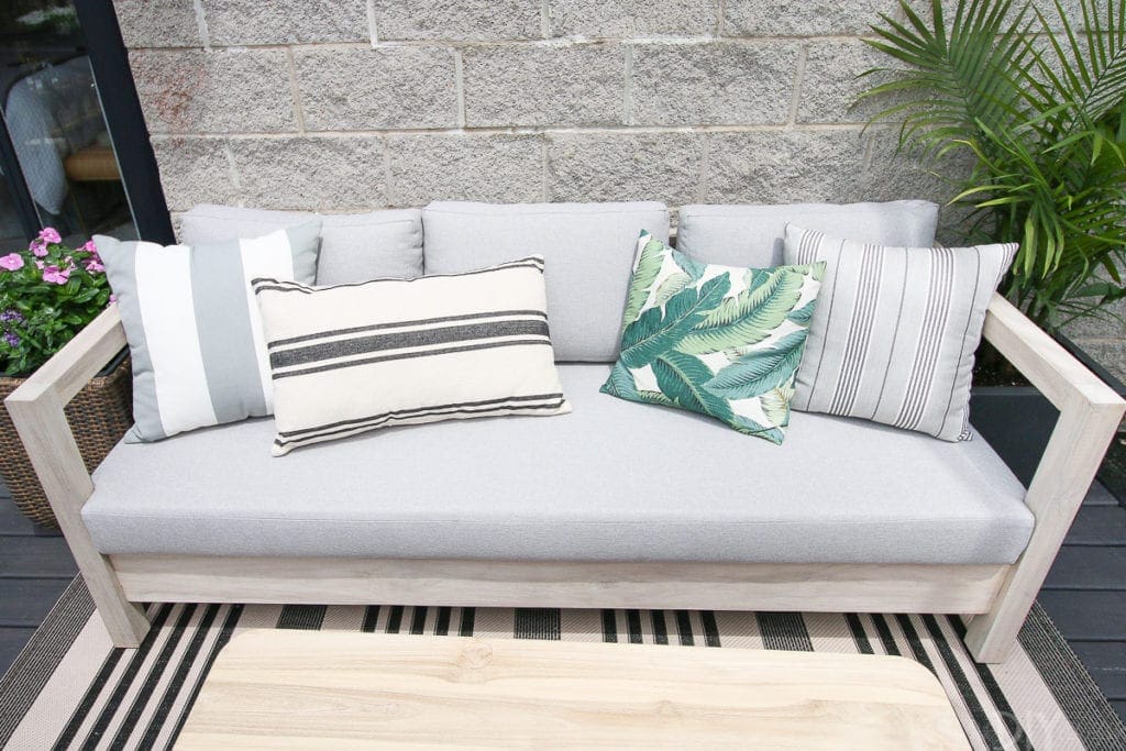 Try an outdoor couch with pillows on your balcony