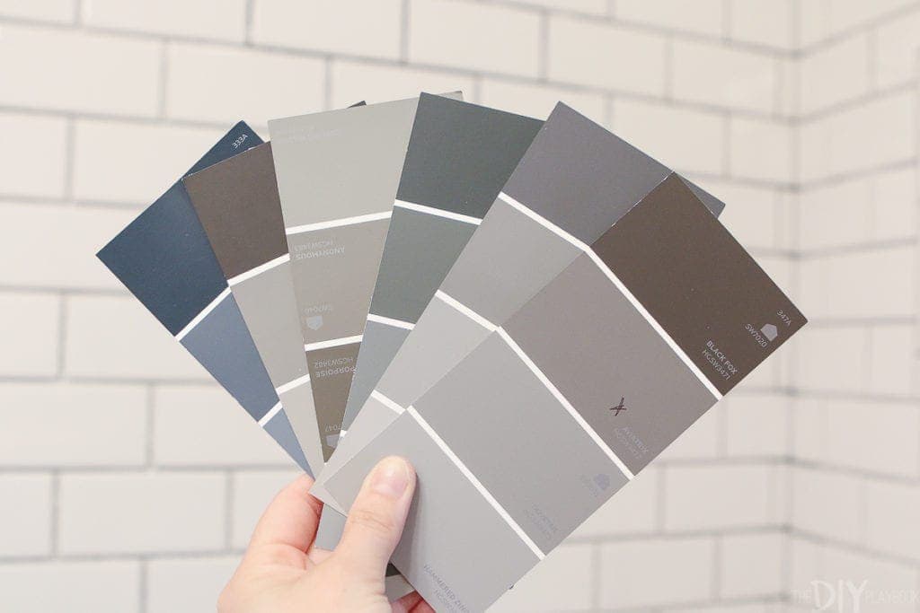 Dark gray paint swatches in a white bathroom
