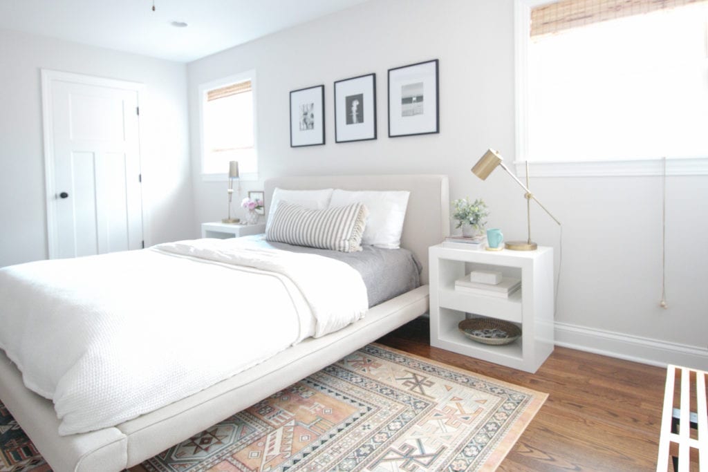 light, bright master bedroom with white nightstands