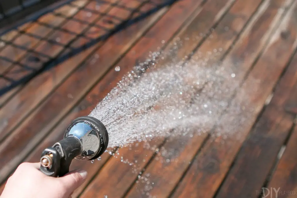 Hose down a deck with water