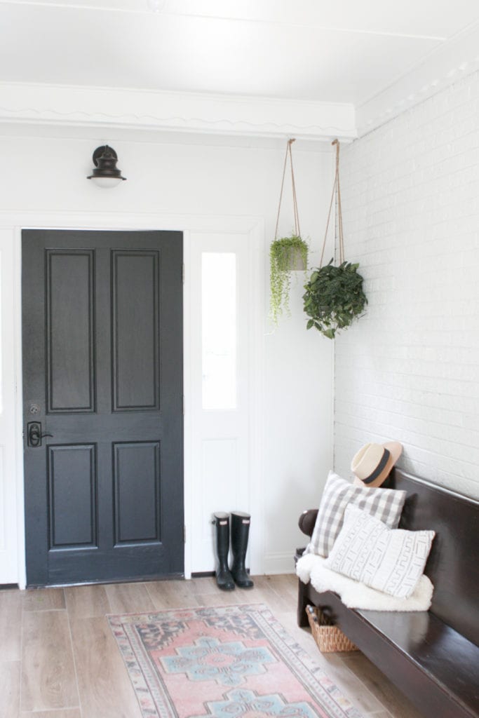 Black and white mudroom makeover with greenery