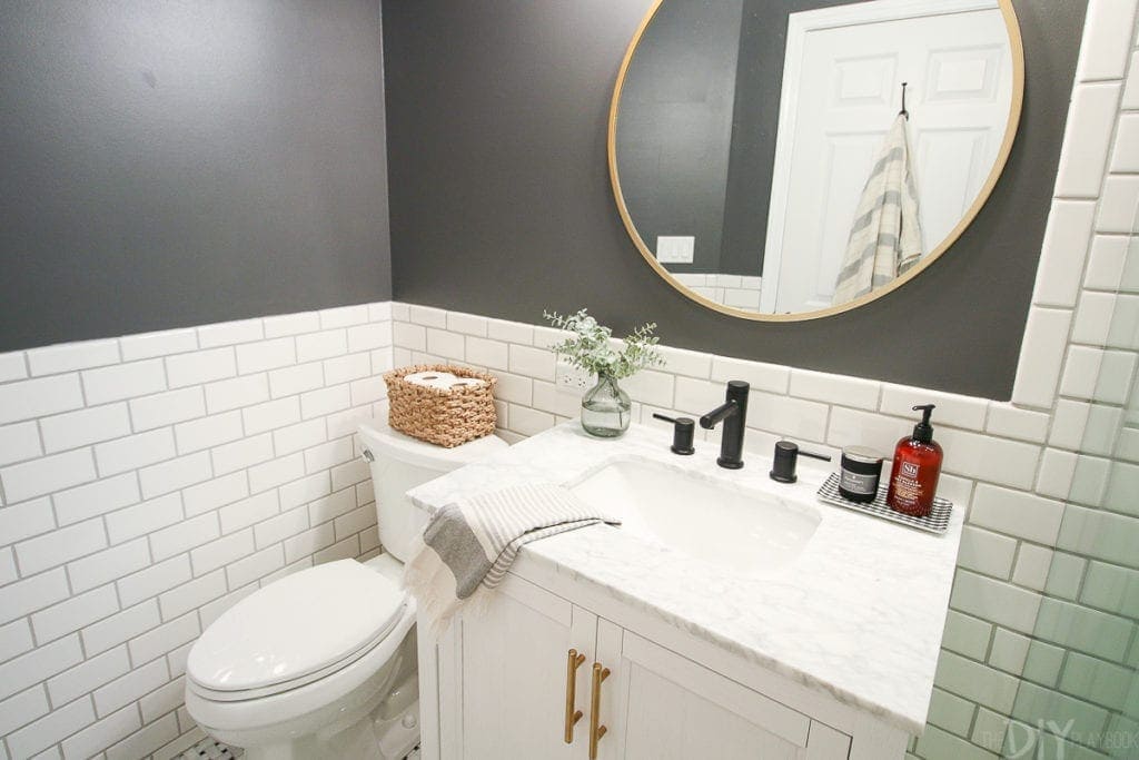 Dark gray walls and white subway tile in this new bathroom space