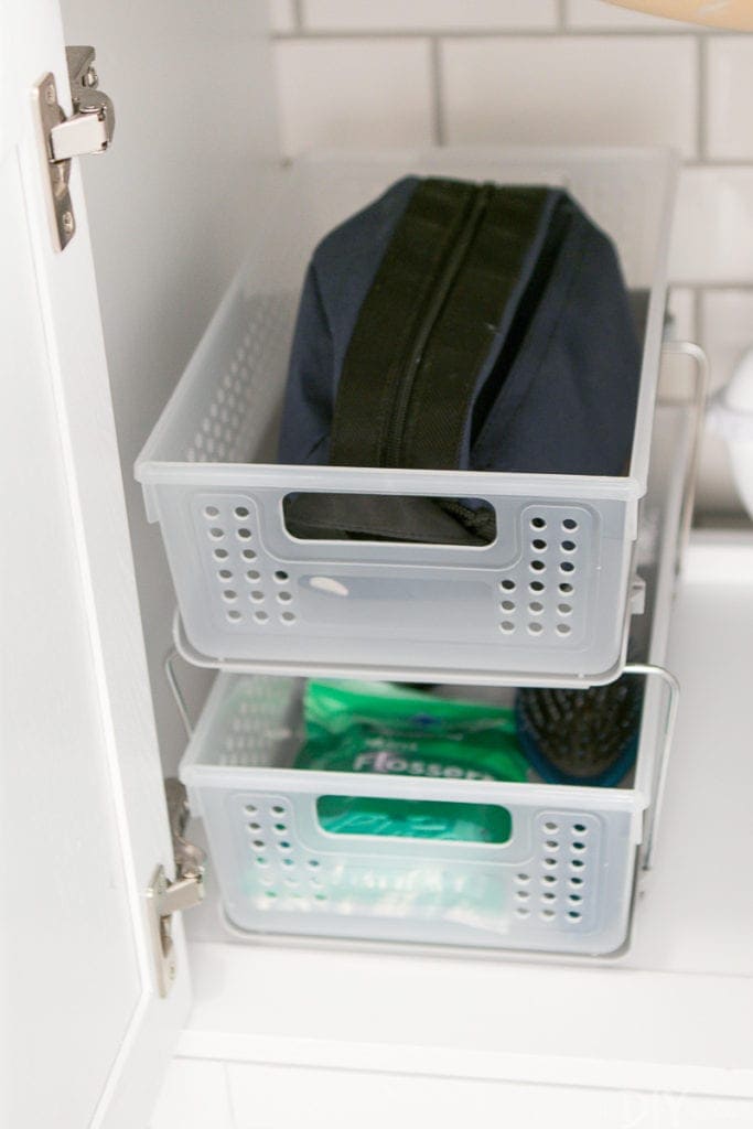 Try a double decker pull out bin to make the most of a bathroom cabinet