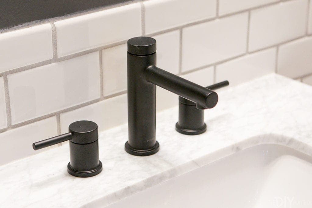 This matte black faucet looks crisp and classic on this marble vanity top