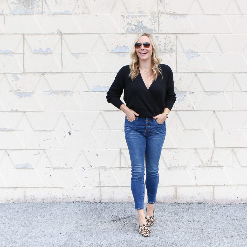 Black sweater with high-waisted jeans and leopard flats for fall