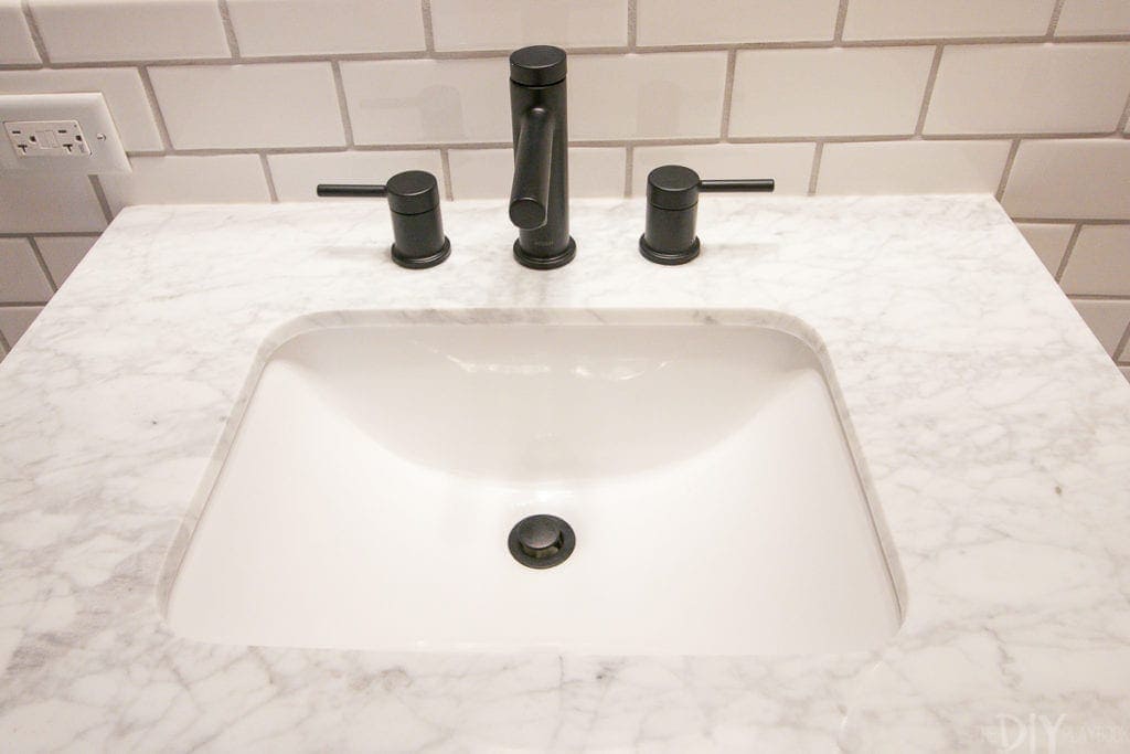 Consider using a black matte faucet with a white vanity