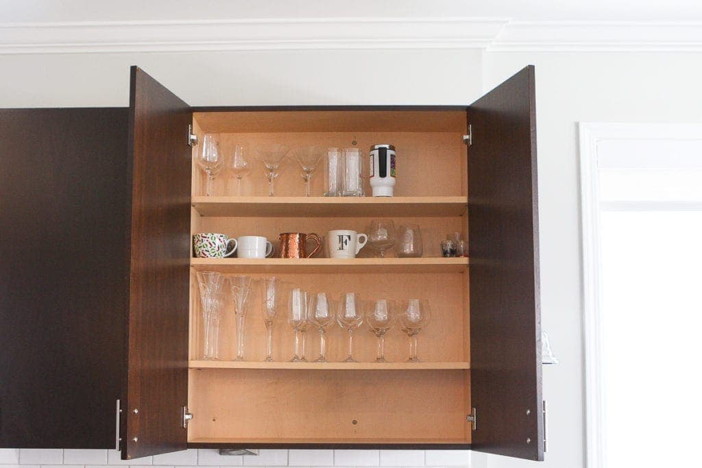 A kitchen cabinet with glassware