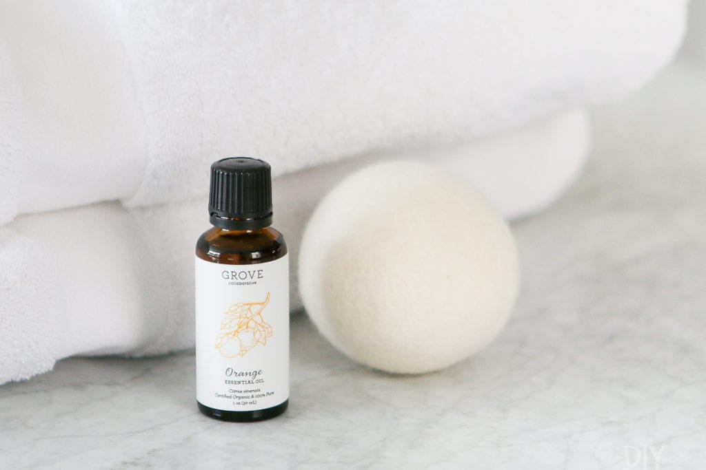 Orange essential oils and a wool dryer ball