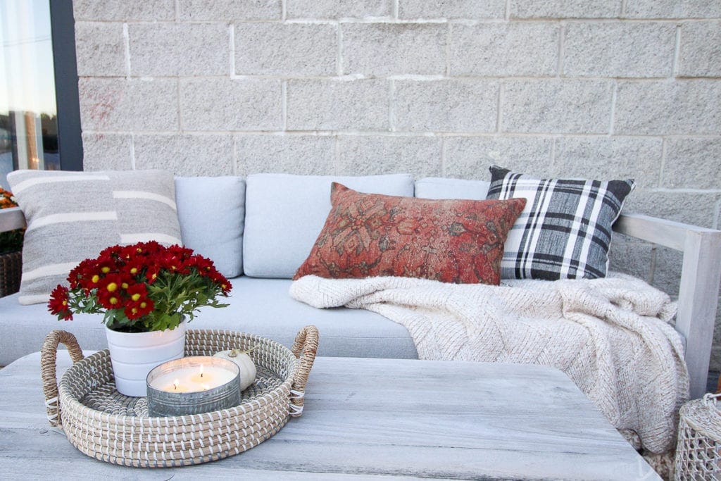 black and white checkered pillows on an outdoor sofa