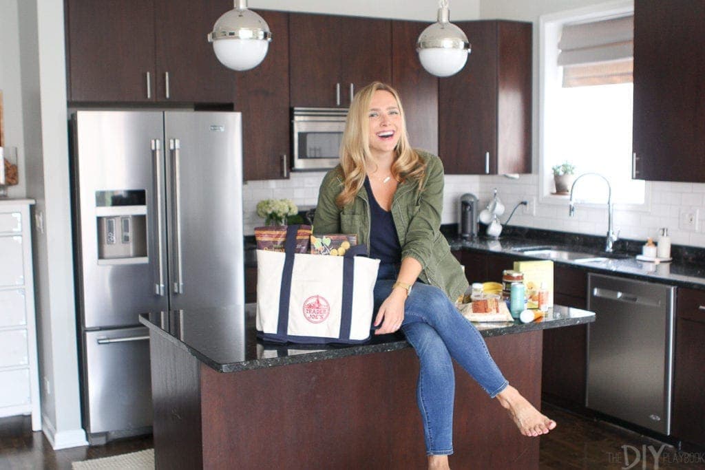 Casey with items from Trader Joe's in kitchen