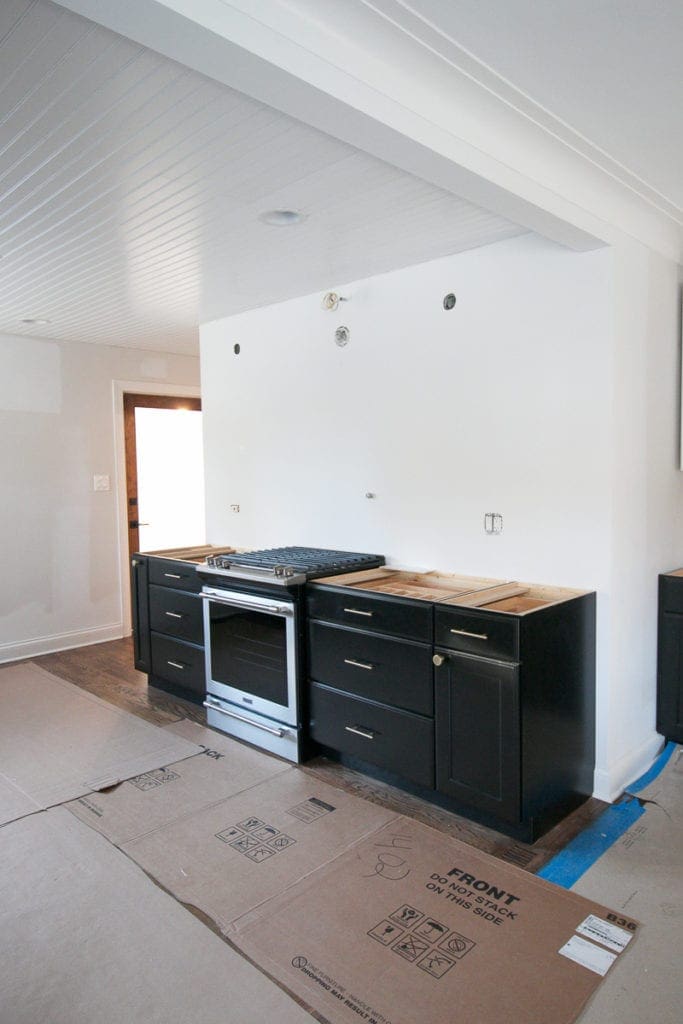 maytag stove next to black lower cabinets