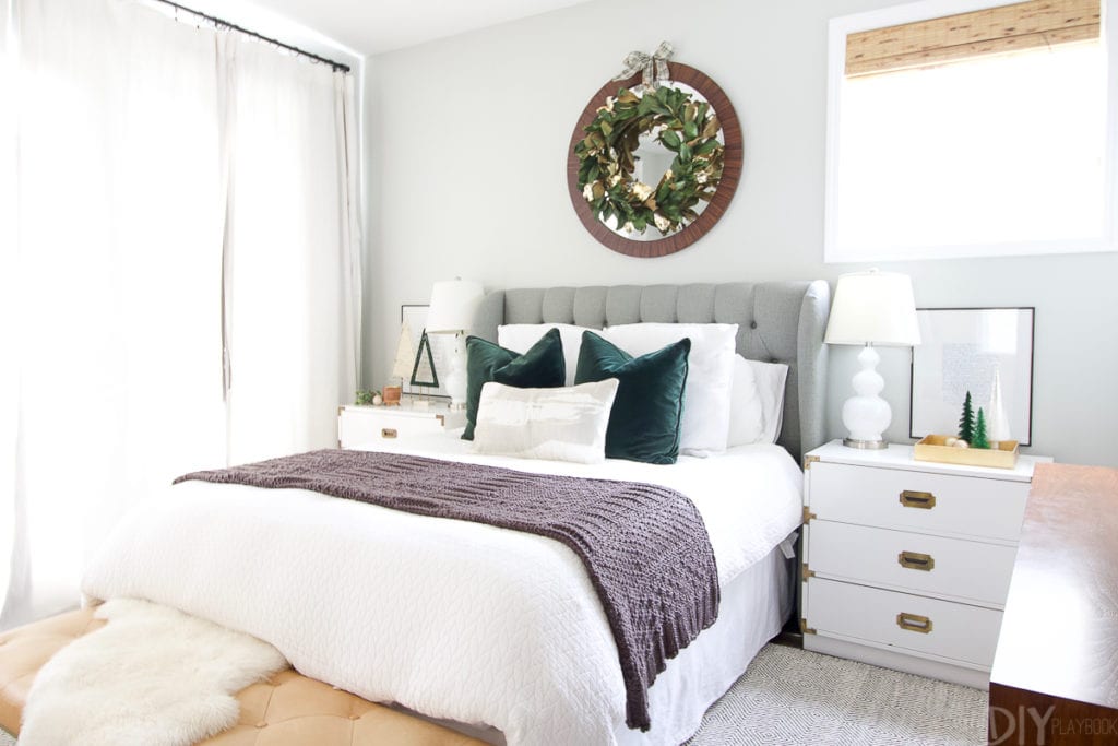 Decorating your bedroom for the holidays with a big wreath over the bed