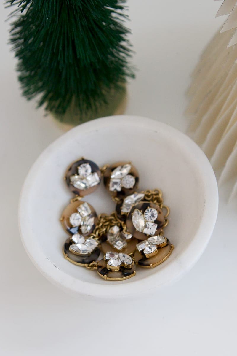 using a small dish to collect jewelry