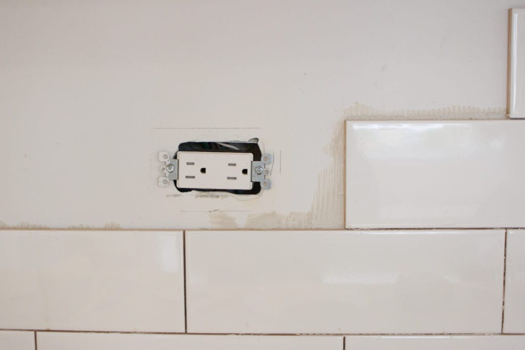tiling around an electrical outlet