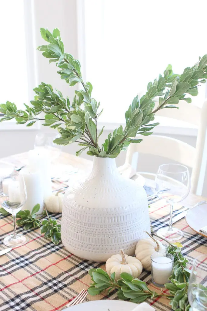 Add fresh greenery to a white vase