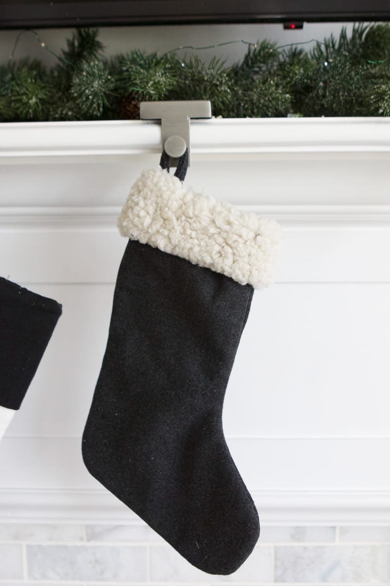 Adding a baby stocking to the fireplace