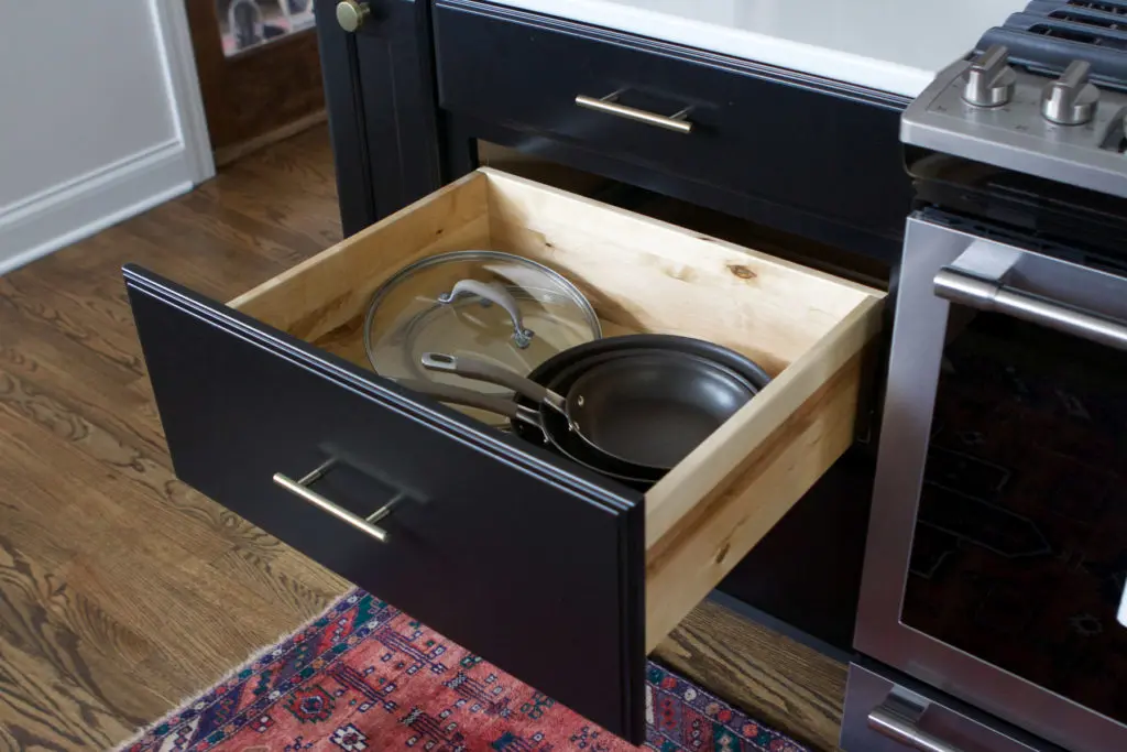 organizing pots and pans in large drawers