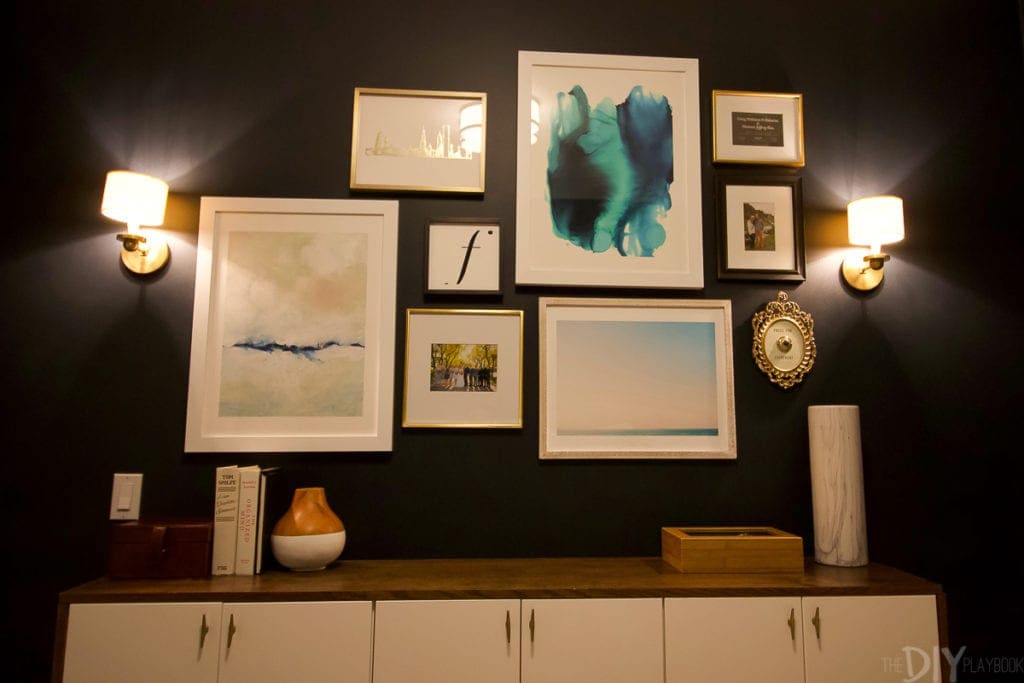 Gallery wall with gold sconces