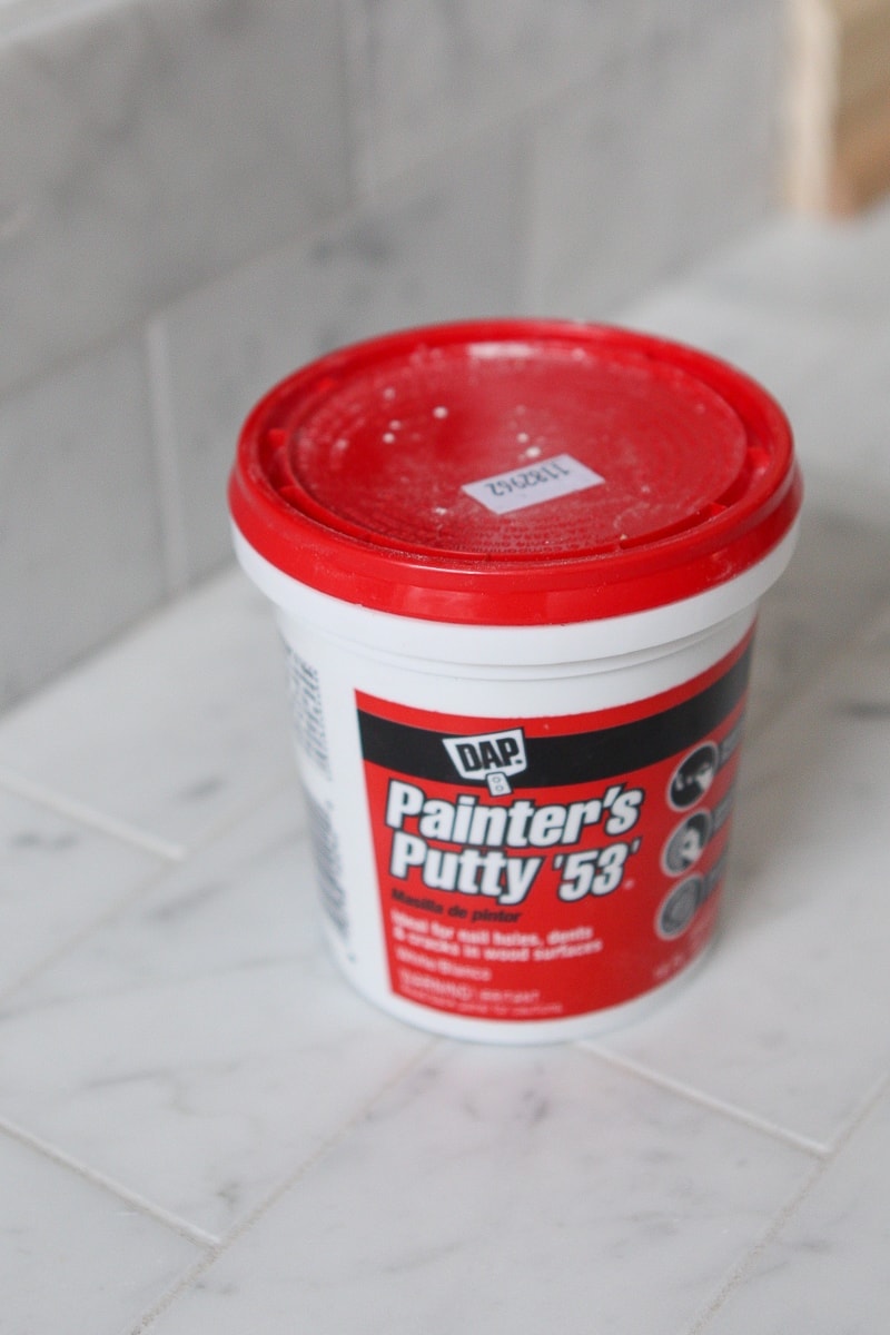 Use painter's putty to fill nail holes