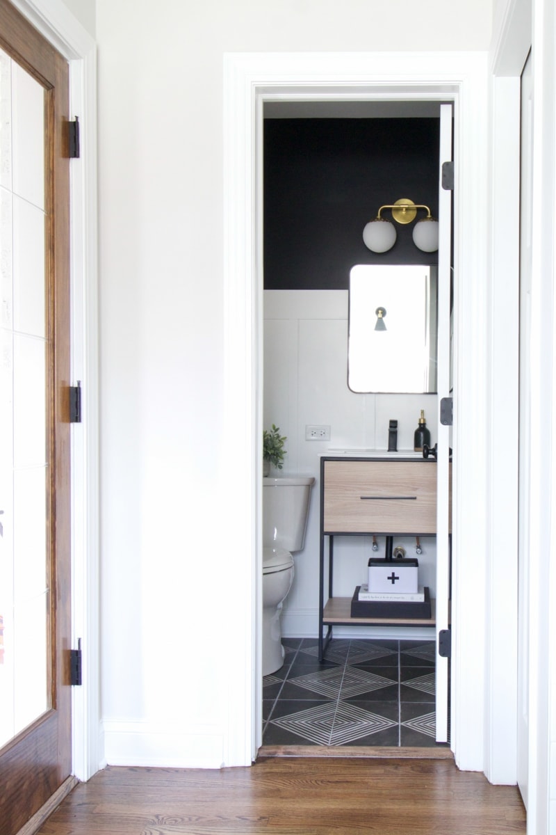 A powder room makeover with white board and batten and black paint