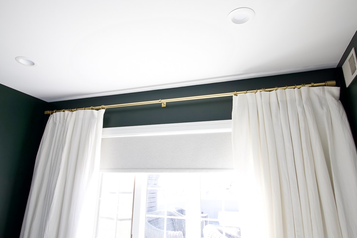 White curtains with a brass curtain rod