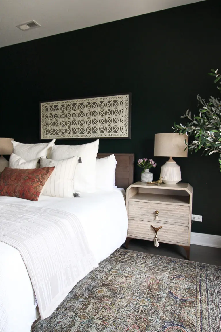 Dark green guest room with white bedding