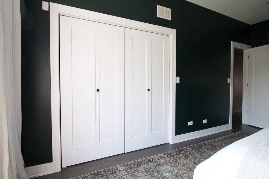 White closet doors with black handles